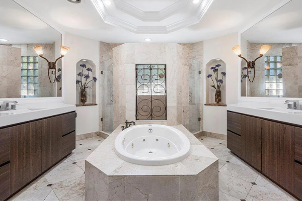 Luxury bathroom with marble tub, columns, and classic European decor.