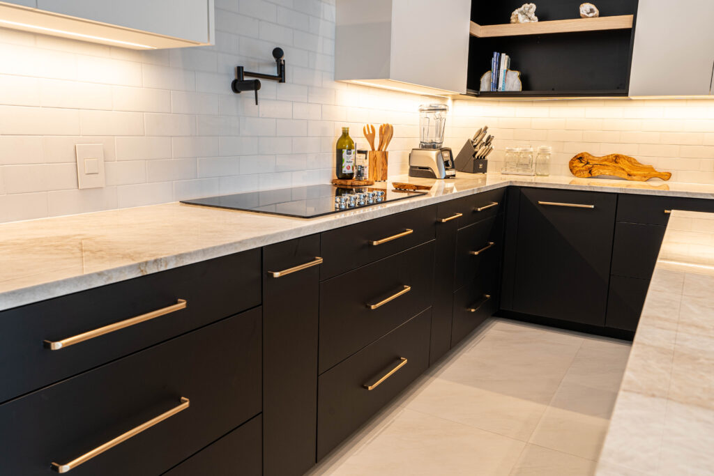 Compact kitchen with wine cooler, cabinets with open shelving, and marble counters.