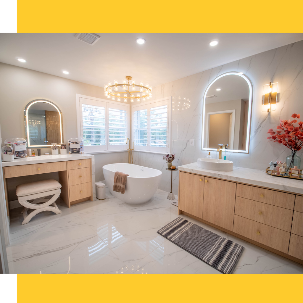 Luxury bathroom featuring wood vanity, chandelier, and polished tile flooring.
