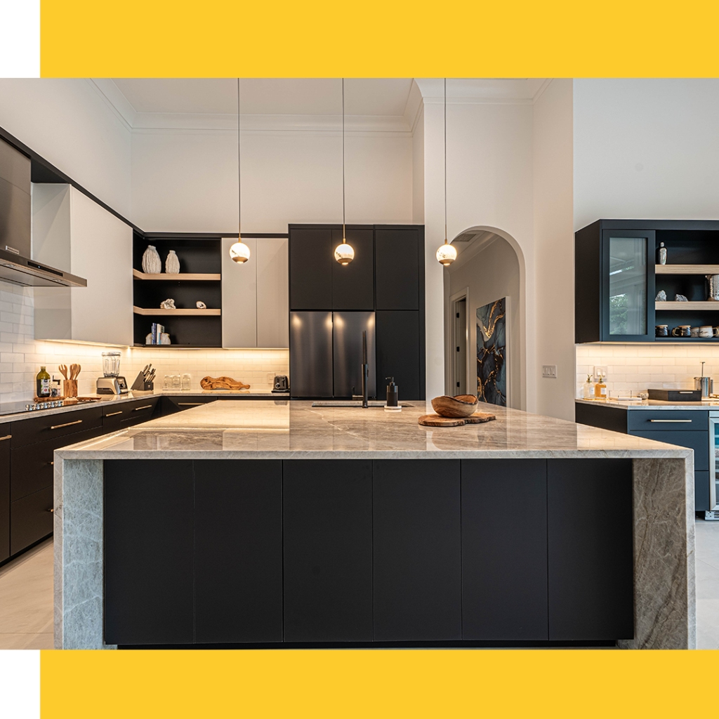 Contemporary kitchen with black island, pendant lighting, and gold faucet.
