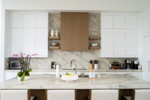 Custom kitchen design in Port St. Lucie by Mahogany Kitchens. Warm and cozy kitchen with wood cabinetry, white counters, and table setting.