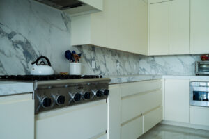 Kitchen with built-in stovetop and cream-colored cabinets.
