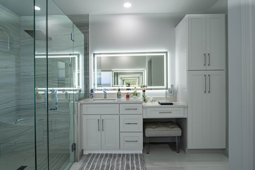 Contemporary bathroom with dual sinks, black accents, and marble walls.