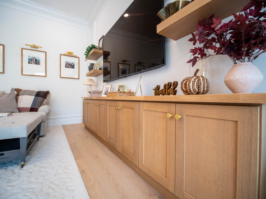 Custom built-in wooden cabinetry with seasonal home decor and floating shelves