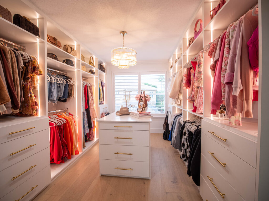Boutique-style walk-in closet Boca Raton. Closet with glamorous lighting, high storage, and curated fashion pieces.