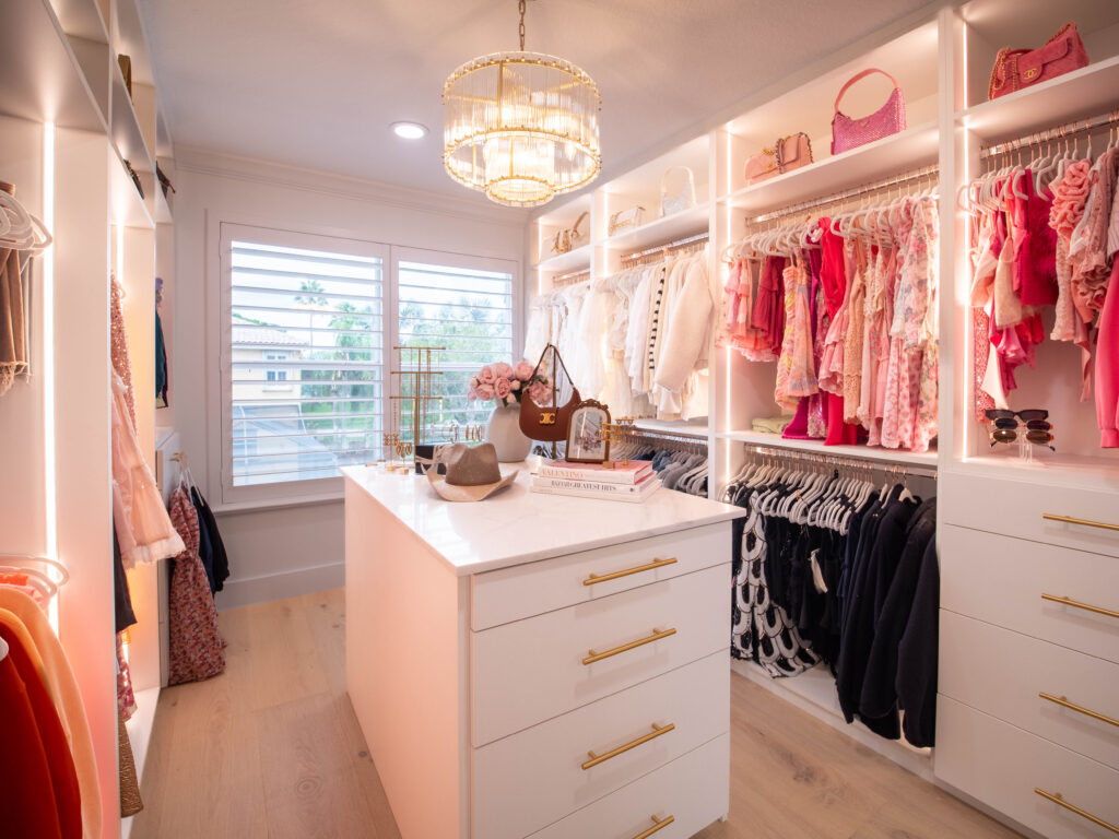 Walk-in closet featuring vanity station and built-in shelves.